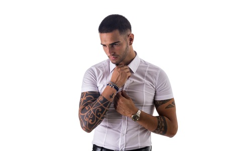 Handsome young man in white shirt and jeans posing isolated on white background in studio, smilingの写真素材