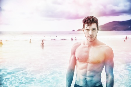 Heavily filtered shot of a handsome young man standing on a beach in Phuket Island, Thailand,...