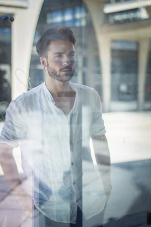 One handsome young man in urban setting in European city