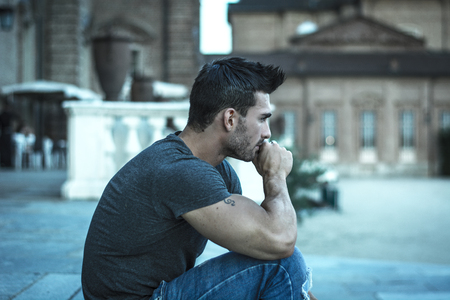 Handsome muscular man with tattoo posing in European city center, Turin, Italyの写真素材