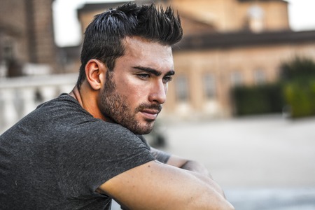 Handsome muscular man with tattoo posing in European city center, Turin, Italyの写真素材