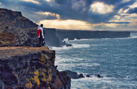 Stormy sea near rough cliffs in Icelandの写真素材
