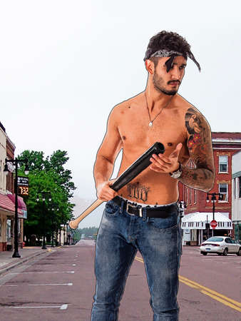 Man with baseball bat on city streetの写真素材