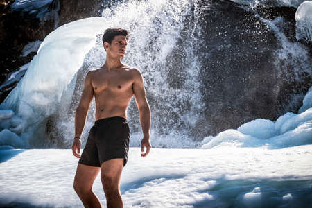 Shirtless Young Athletic Man Outdoor in Country Standing on Snow.の写真素材