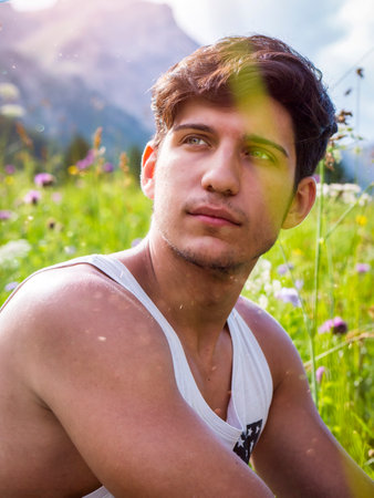 Half body shot of handsome young man outdoor, looking awayの写真素材