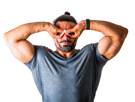 Muscular adult man gesturing mask, isolated on white