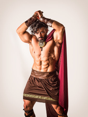 Muscular man posing in roman gladiator costumeの写真素材
