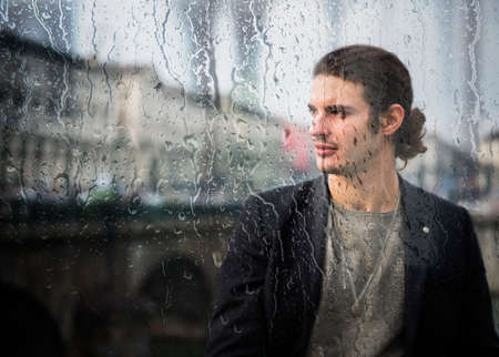 Elegant young man outdoor wearing wool coatの写真素材