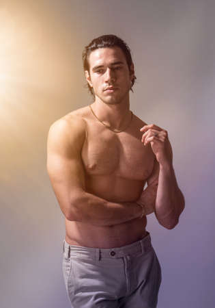 Three quarters shot of handsome shirtless athletic young manの写真素材