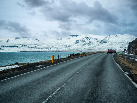 Car riding towards mountains in Iceland in winterの写真素材