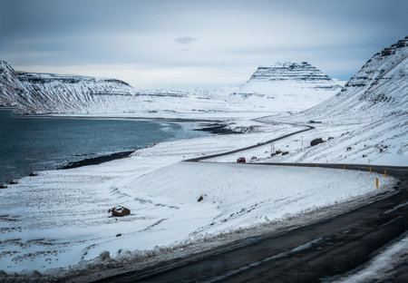 Car riding towards mountains in Iceland in winterの写真素材