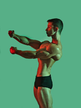 Handsome young male bodybuilder in studio shotの写真素材