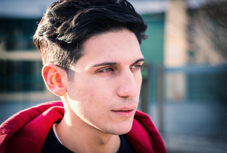 Headshot of one handsome young man in urban settingの写真素材