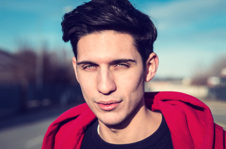 Headshot of one handsome young man in urban setting