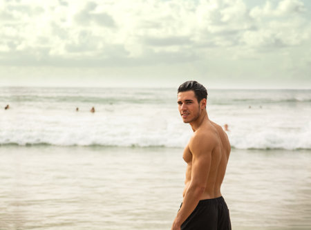 Handsome young man standing on a beach in Phuket Island, Thailandの写真素材