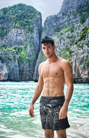 Handsome young man standing on a beach in Phuket Island, Thailandの写真素材