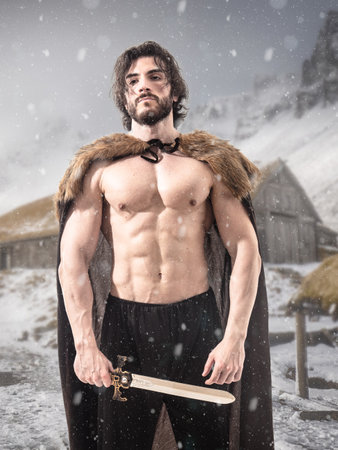 Brutal viking man in fur cloak with swordの写真素材
