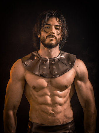 Muscular man posing in roman or spartan gladiator costume
