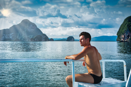 Photo of a man enjoying a peaceful moment on a boat in the waterの写真素材