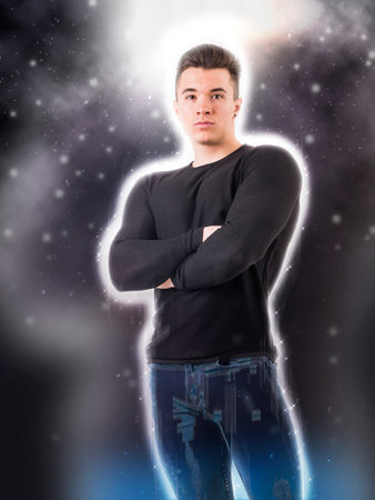 A man standing with his arms crossed in front of him, surrounded by a halo of lightの写真素材