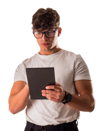 A man in glasses is looking at a tabletの写真素材