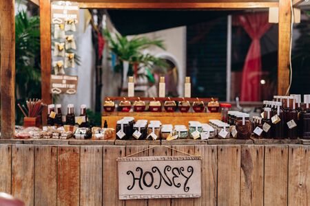 Wooden counter with glass jars of honey