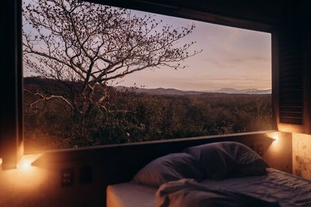 Concrete table and hammocks in the house among the jungleの写真素材