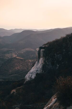 Girl on top of a white mountain with blue lakes and springs in Mexico hierve del aguaの写真素材