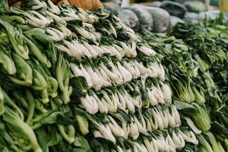Green vegetables hanging in the marketの写真素材