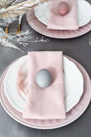Setting Easter table with colored eggsの写真素材
