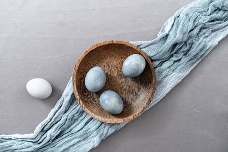 Setting Easter table with colored eggs