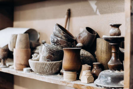 Handmade wooden tableware stands on a shelfの写真素材