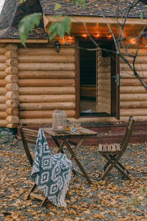 Wicker candlestick on a table near a house on the streetの写真素材