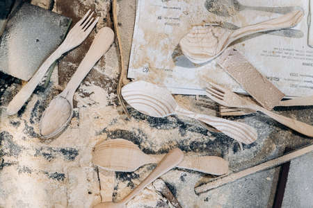 Handmade wooden tableware stands on a shelfの写真素材