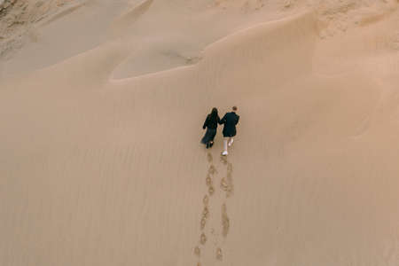 Drone view of a couple in love on the sand dunesの写真素材