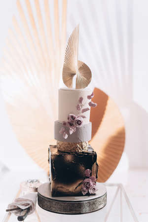 Tiered wedding cake decorated with decor