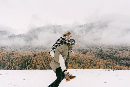 A couple in love walks in the snow among the mountains in autumn