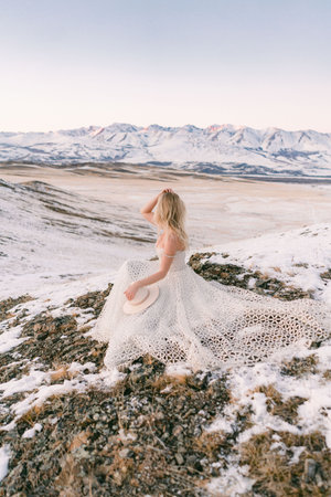 A couple in love walks in the snow among the mountains in autumnの写真素材