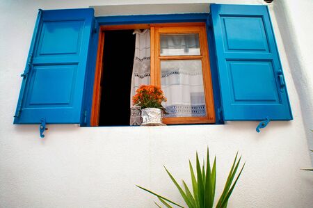 Greece, Cyclades islands, Mykonos, decorative flower pot on a window.の写真素材