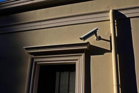Security camera on exterior wall.の写真素材