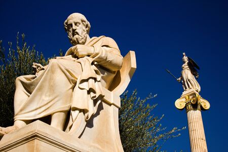 The statues of the ancient Greek philosopher Plato and Greek Goddess Athena outside of the Academy of Athens, Athens, Greece.の写真素材