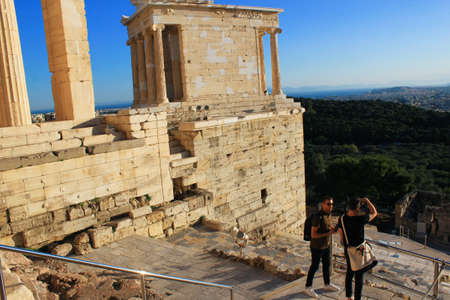Greece, Athens, June 16 2020 - Tourists enjoy the view to Athens city from Acropolis' Propylaia.のeditorial素材