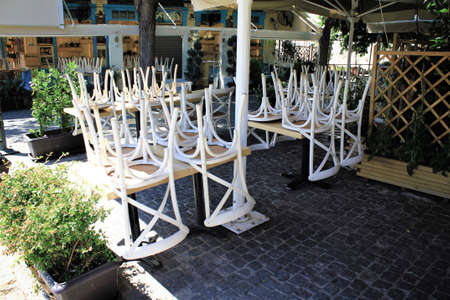 Greece, Athens, June 17 2020 - Chairs stacked outside of a traditional restaurant in the touristic district of Monastiraki, due to lack of customers. Despite the low coronavirus rate and a long list of new safety rules, tourism traffic in Greece is quite のeditorial素材