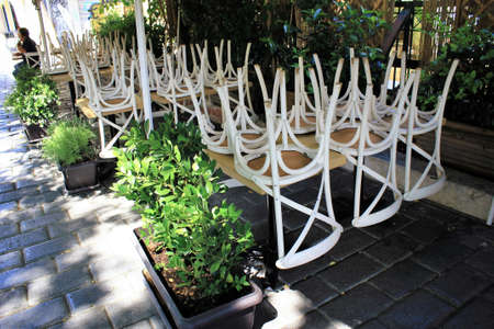 Greece, Athens, June 17 2020 - Chairs stacked outside of a traditional restaurant in the touristic district of Monastiraki, due to lack of customers. Despite the low coronavirus rate and a long list of new safety rules, tourism traffic in Greece is quite のeditorial素材