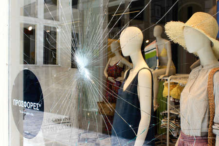 Greece, Athens, June 28 2020 - Broken glass of store window at Ermou street, in the commercial center of Athens, after vandalism made by anarchists.のeditorial素材