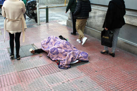 An unidentified homeless person begging for money in the streets of Athens, Greece, February 1 2020.のeditorial素材
