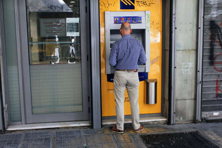 Man using ATM machine in the center of Athens in Greece, July 27 2020.のeditorial素材