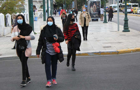 People walking in the center of Athens after the announcement for a second lockdown in Greece from 7th to 30th of November 2020, due to Covid-19 outbreak - Athens, Greece, November 6 2020.のeditorial素材