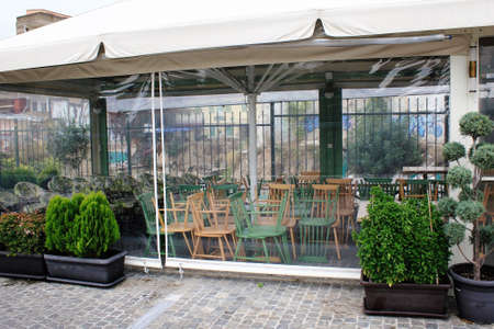 Greece, Athens, November 3 2020 - Chairs, tables and other furniture stacked outside closed cafe-restaurant around Acropolis hill, after the announcement for Covid-19 lockdown.のeditorial素材