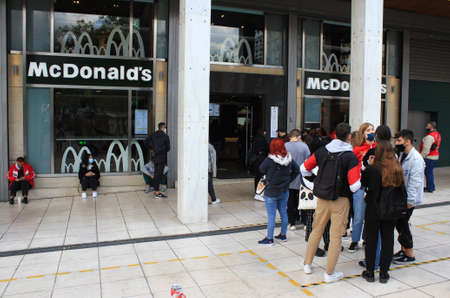 Customers queue to get into Mc Donald's fast food store at Syntagma in Athens, after the...